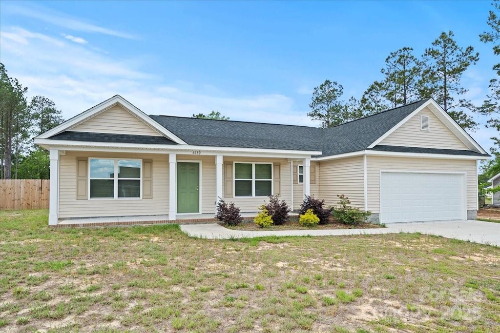 6680 George Coker Ln, Cheraw, SC 29520 - single story home featuring a garage, concrete driveway, covered porch, and roof with shingles