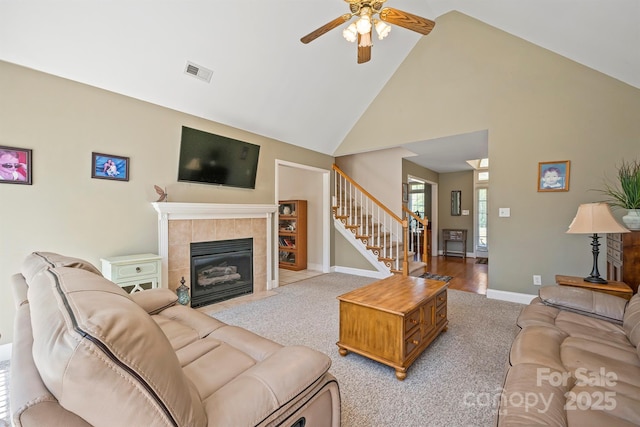 14340 Kendalton Meadow Dr, Mint Hill, NC 28227 - living area with light colored carpet, high vaulted ceiling, a ceiling fan, stairway, and baseboards