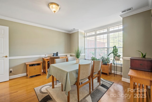 14340 Kendalton Meadow Dr, Mint Hill, NC 28227 - dining area featuring healthy amount of natural light, ornamental molding, baseboards, and light wood-type flooring