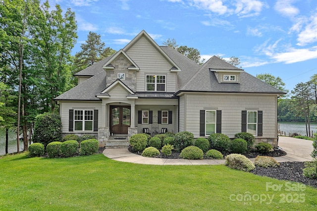 112 Nautilus Ct, Troutman, NC 28166 - craftsman-style house with roof with shingles, a front lawn, stone siding, and french doors