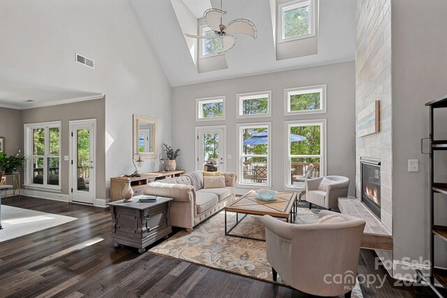 112 Nautilus Ct, Troutman, NC 28166 - living area with a high ceiling, a tile fireplace, dark wood finished floors, healthy amount of natural light, and baseboards