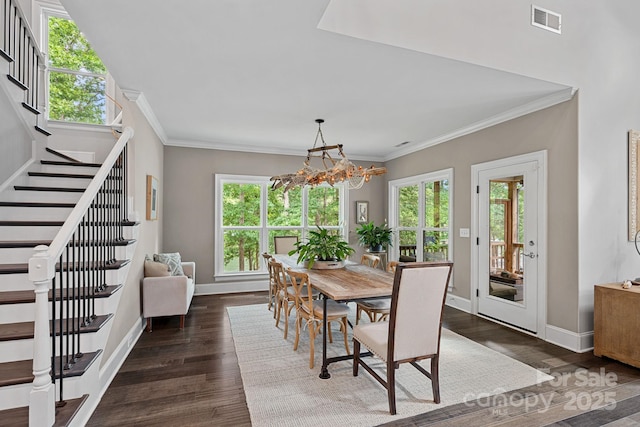 112 Nautilus Ct, Troutman, NC 28166 - dining space featuring stairs, a chandelier, dark wood finished floors, baseboards, and ornamental molding