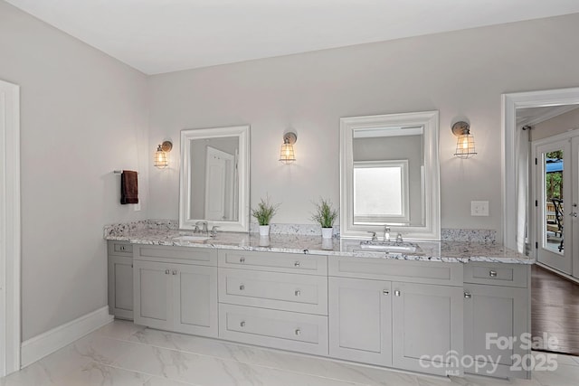 112 Nautilus Ct, Troutman, NC 28166 - bathroom with double vanity, baseboards, and marble look tiles