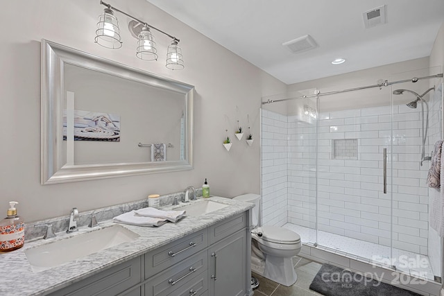 112 Nautilus Ct, Troutman, NC 28166 - bathroom with a stall shower, toilet, double vanity, tile patterned floors, and recessed lighting