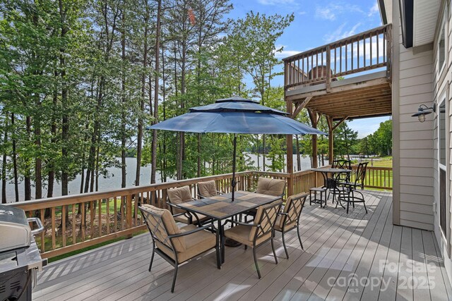 112 Nautilus Ct, Troutman, NC 28166 - deck with outdoor dining space, grilling area, a water view, and view of scattered trees