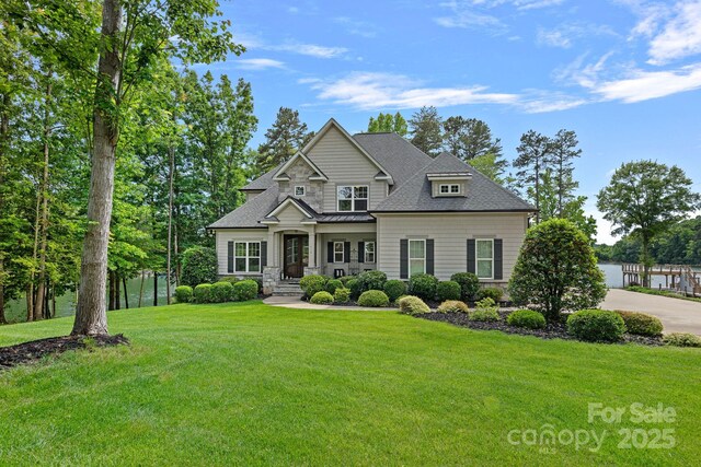 112 Nautilus Ct, Troutman, NC 28166 - view of front facade featuring a front yard, stone siding, and roof with shingles