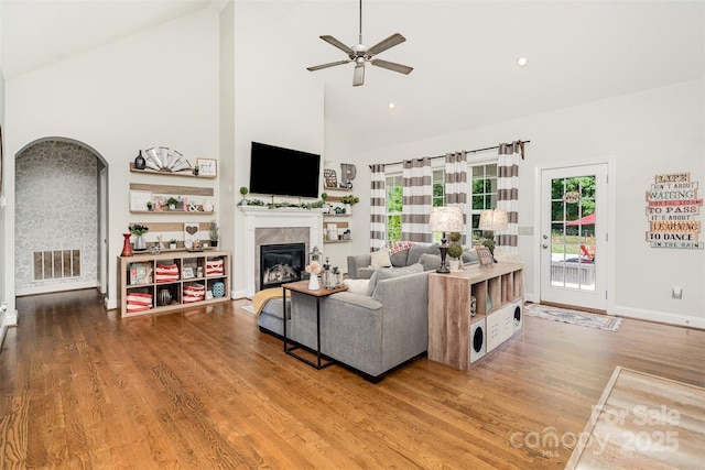 6603 Havencrest Dr, Denver, NC 28037 - living room featuring high vaulted ceiling, wood finished floors, a tile fireplace, ceiling fan, and baseboards