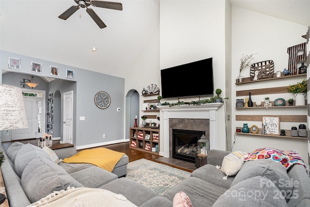 6603 Havencrest Dr, Denver, NC 28037 - living room featuring arched walkways, ceiling fan, high vaulted ceiling, wood finished floors, and a fireplace