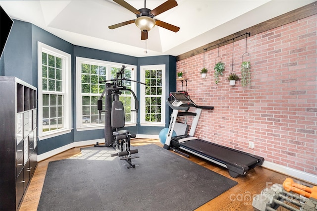 6603 Havencrest Dr, Denver, NC 28037 - workout room featuring brick wall, baseboards, a ceiling fan, and wood finished floors