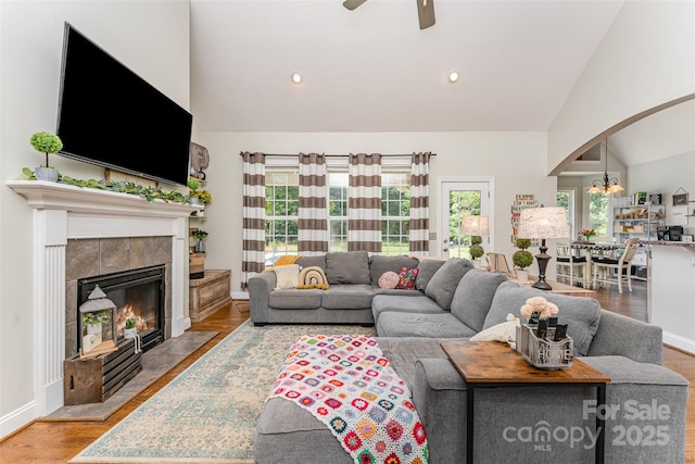 6603 Havencrest Dr, Denver, NC 28037 - living area featuring arched walkways, a ceiling fan, a fireplace, high vaulted ceiling, and recessed lighting