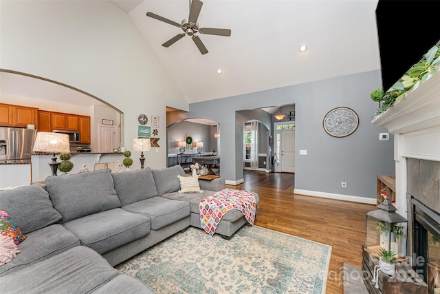 6603 Havencrest Dr, Denver, NC 28037 - living area featuring arched walkways, ceiling fan, high vaulted ceiling, a fireplace, and wood finished floors