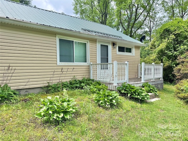 exterior space with metal roof and a wooden deck
