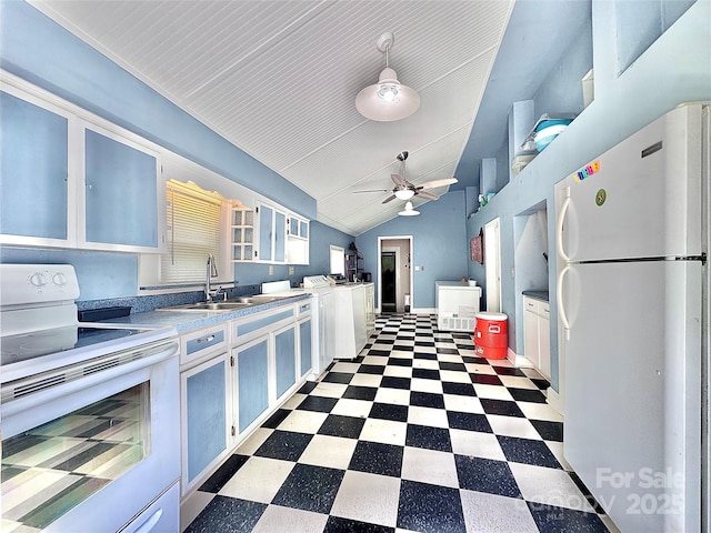 kitchen with a sink, white appliances, tile patterned floors, vaulted ceiling, and a ceiling fan