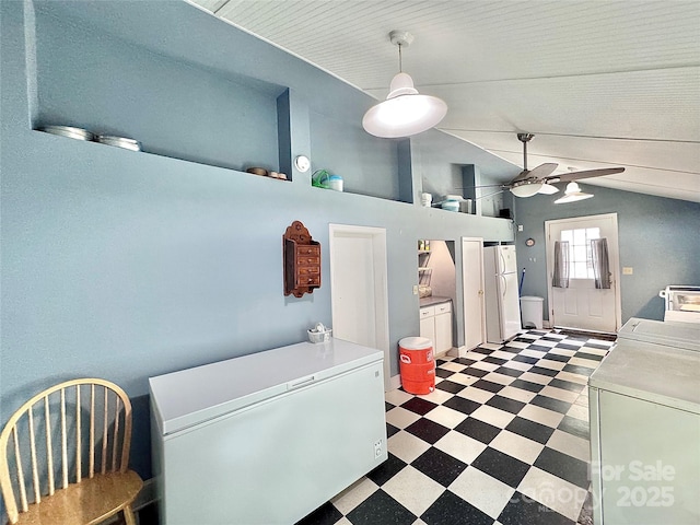 interior space featuring washing machine and clothes dryer, light floors, ceiling fan, and laundry area