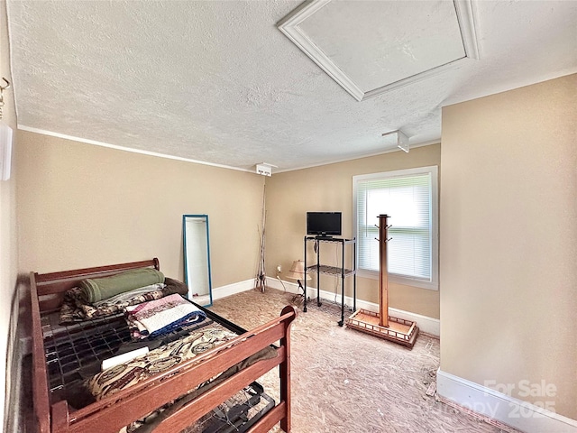bedroom featuring light colored carpet, a textured ceiling, and baseboards