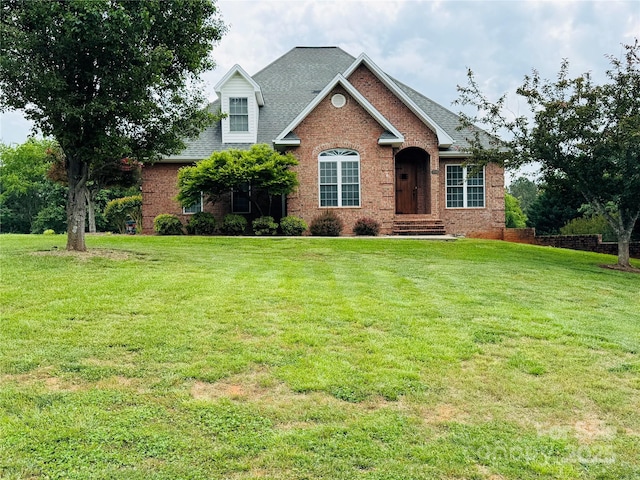 5518 Land Harbour Dr, Granite Falls, NC 28630 - view of front of home featuring roof with shingles, a front yard, and brick siding