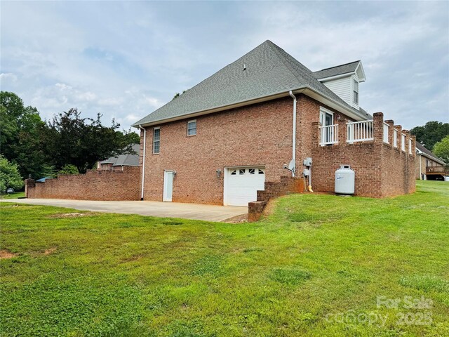 5518 Land Harbour Dr, Granite Falls, NC 28630 - view of side of home featuring roof with shingles, brick siding, a garage, concrete driveway, and a yard