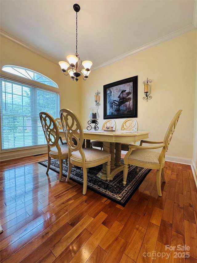 5518 Land Harbour Dr, Granite Falls, NC 28630 - dining room with crown molding, baseboards, a notable chandelier, and wood-type flooring