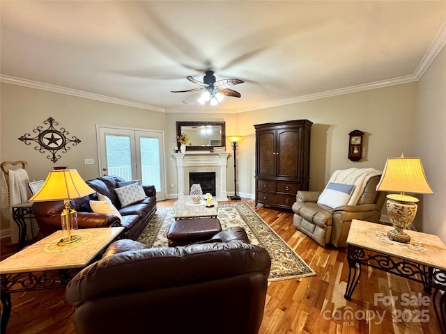 5518 Land Harbour Dr, Granite Falls, NC 28630 - living room featuring ceiling fan, a fireplace, wood finished floors, baseboards, and ornamental molding