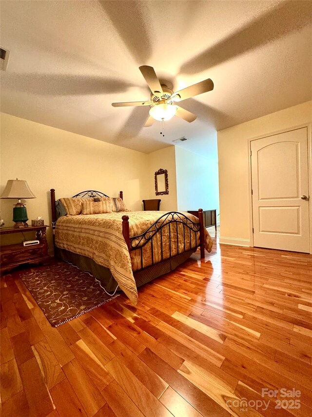 5518 Land Harbour Dr, Granite Falls, NC 28630 - bedroom with visible vents, a textured ceiling, light wood finished floors, and ceiling fan