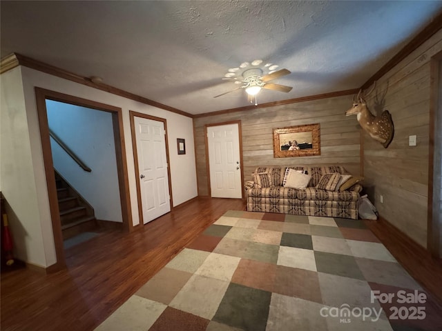5518 Land Harbour Dr, Granite Falls, NC 28630 - foyer with wooden walls, crown molding, stairs, a ceiling fan, and wood finished floors