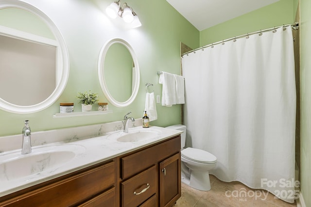 bathroom featuring toilet, tile patterned floors, double vanity, and a sink