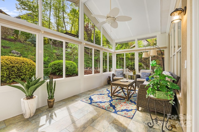 sunroom / solarium with beam ceiling and ceiling fan