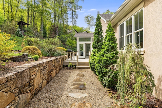 exterior space with stucco siding and a wooden deck