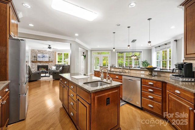 14 Larue Ct, Biltmore Lake, NC 28715 - kitchen featuring appliances with stainless steel finishes, a sink, a fireplace, ornamental molding, and healthy amount of natural light