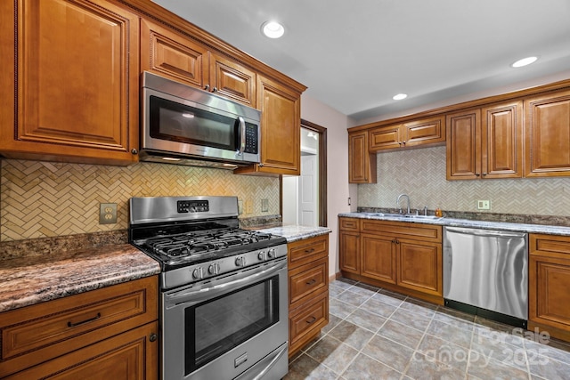 1128 Forest St, Mars Hill, NC 28754 - kitchen featuring stainless steel appliances, a sink, decorative backsplash, brown cabinets, and recessed lighting