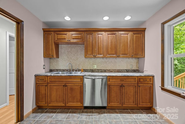 1128 Forest St, Mars Hill, NC 28754 - kitchen with stainless steel dishwasher, a sink, brown cabinets, decorative backsplash, and stone counters