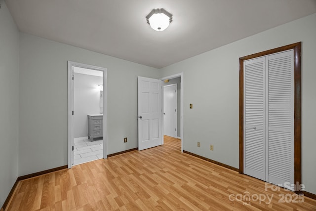1128 Forest St, Mars Hill, NC 28754 - unfurnished bedroom with light wood-style flooring, baseboards, a closet, and ensuite bathroom