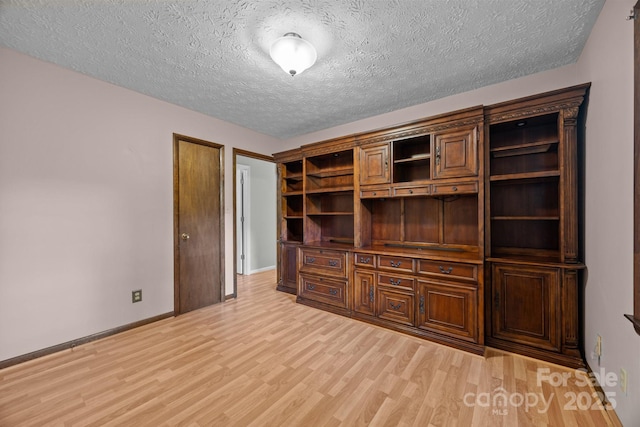1128 Forest St, Mars Hill, NC 28754 - unfurnished living room with light wood-style floors, a textured ceiling, and baseboards