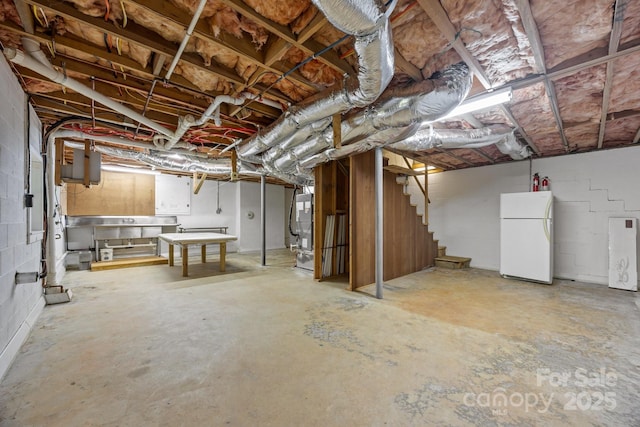 1128 Forest St, Mars Hill, NC 28754 - unfinished basement with freestanding refrigerator, concrete block wall, and stairway