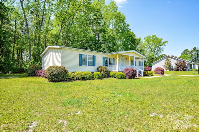 manufactured / mobile home with a porch and a front lawn