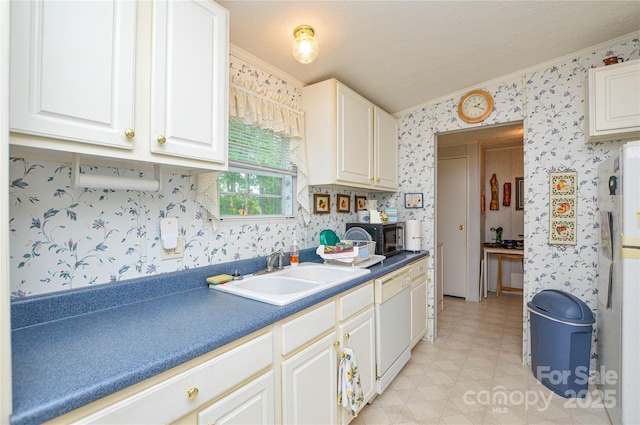 kitchen featuring a sink, crown molding, black microwave, white dishwasher, and wallpapered walls