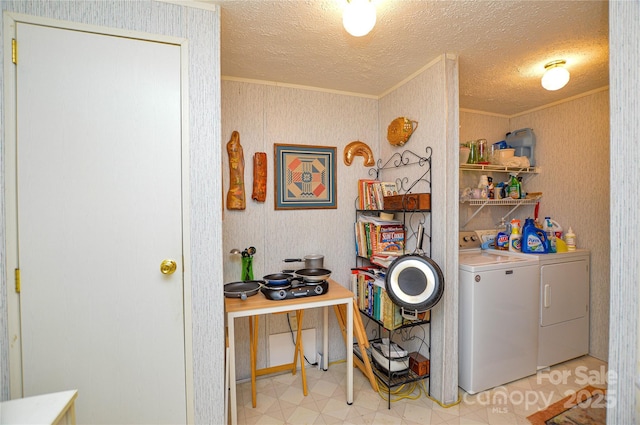 laundry room with washer and clothes dryer, laundry area, light floors, and crown molding