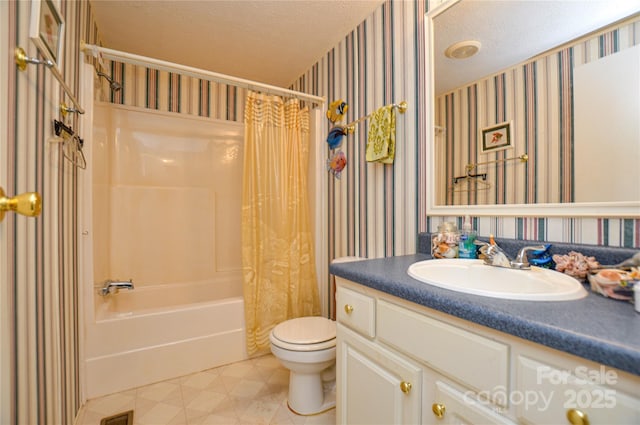 bathroom featuring toilet, vanity, a textured ceiling, shower / bathtub combination with curtain, and wallpapered walls