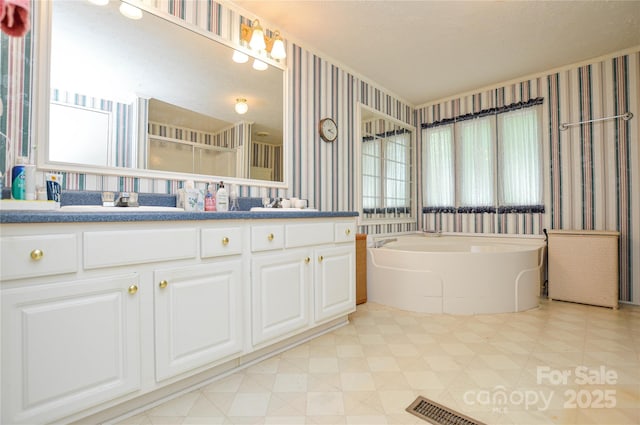 bathroom featuring vanity, a bath, wallpapered walls, and tile patterned floors