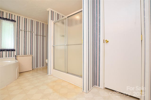 full bath with a textured ceiling, a shower stall, a bath, and tile patterned floors