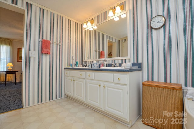bathroom with tile patterned floors, vanity, and wallpapered walls