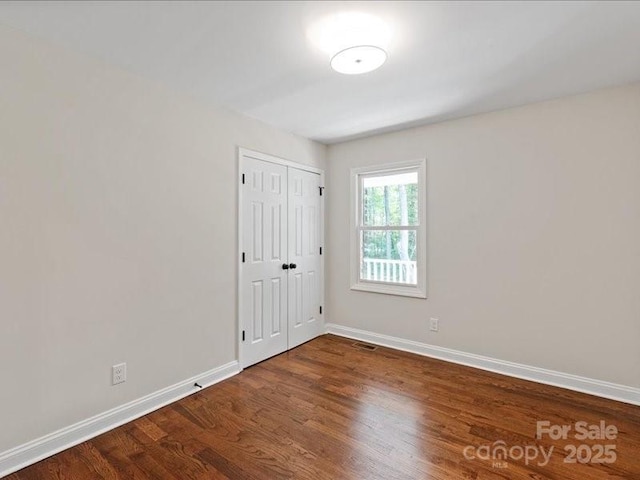 300 Hugh Crocker Rd, Matthews, NC 28104 - unfurnished bedroom with baseboards, wood finished floors, and a closet