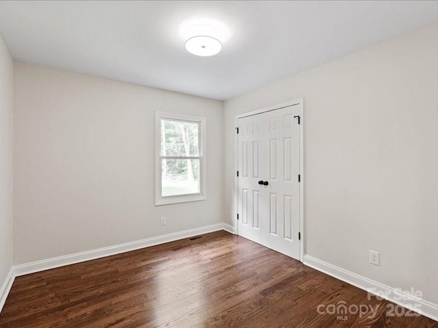 300 Hugh Crocker Rd, Matthews, NC 28104 - unfurnished bedroom with dark wood finished floors, baseboards, and a closet