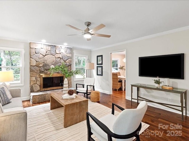 300 Hugh Crocker Rd, Matthews, NC 28104 - living room with crown molding, light wood finished floors, ceiling fan, a stone fireplace, and baseboards
