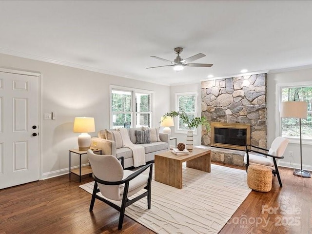 300 Hugh Crocker Rd, Matthews, NC 28104 - living room with ceiling fan, baseboards, ornamental molding, light wood finished floors, and a stone fireplace