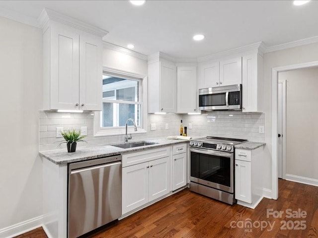 300 Hugh Crocker Rd, Matthews, NC 28104 - kitchen with stainless steel appliances, a sink, white cabinetry, light stone countertops, and ornamental molding