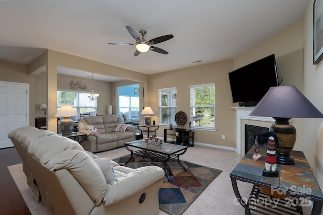 4321 Tucker Chase Dr, Midland, NC 28107 - living area with baseboards, a glass covered fireplace, visible vents, and ceiling fan with notable chandelier