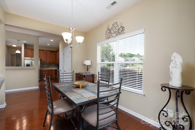 4321 Tucker Chase Dr, Midland, NC 28107 - dining room with baseboards, dark wood-style flooring, a chandelier, and visible vents