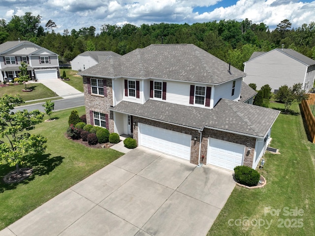 4321 Tucker Chase Dr, Midland, NC 28107 - traditional home with roof with shingles, a front lawn, brick siding, and driveway
