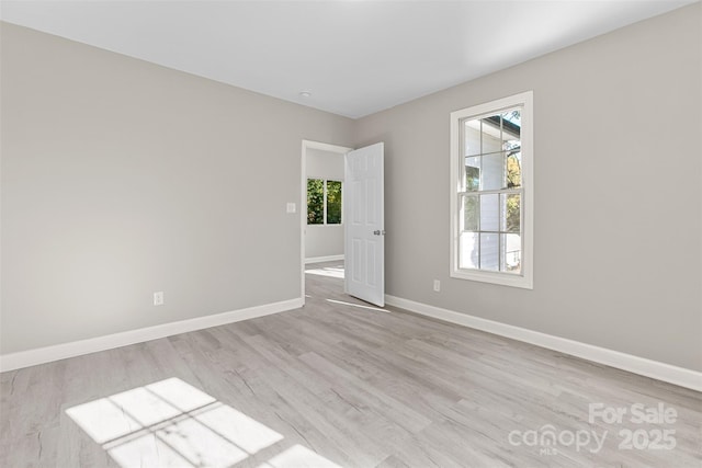 unfurnished room with light wood-style floors and baseboards